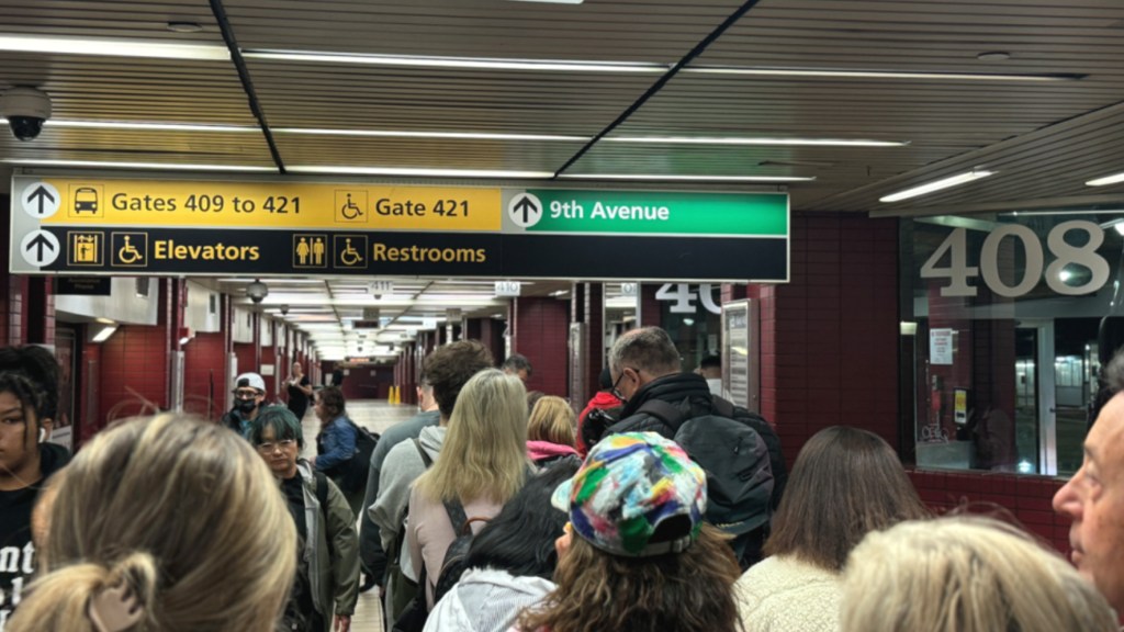 ポートオーソリティ・バスターミナル内の案内標識とウッドベリーコモン行きのバスゲートへのアクセス方法